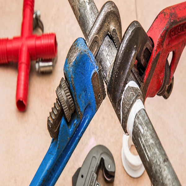 plumber at work pipe wrench